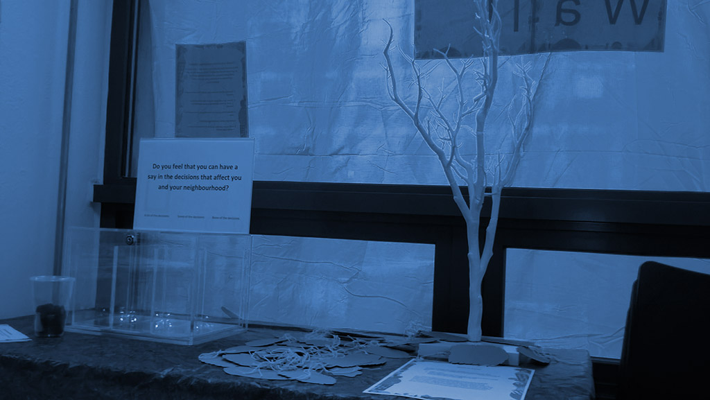 noticeboard and desk with leafless tree on the table